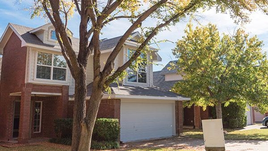 front of home with tree